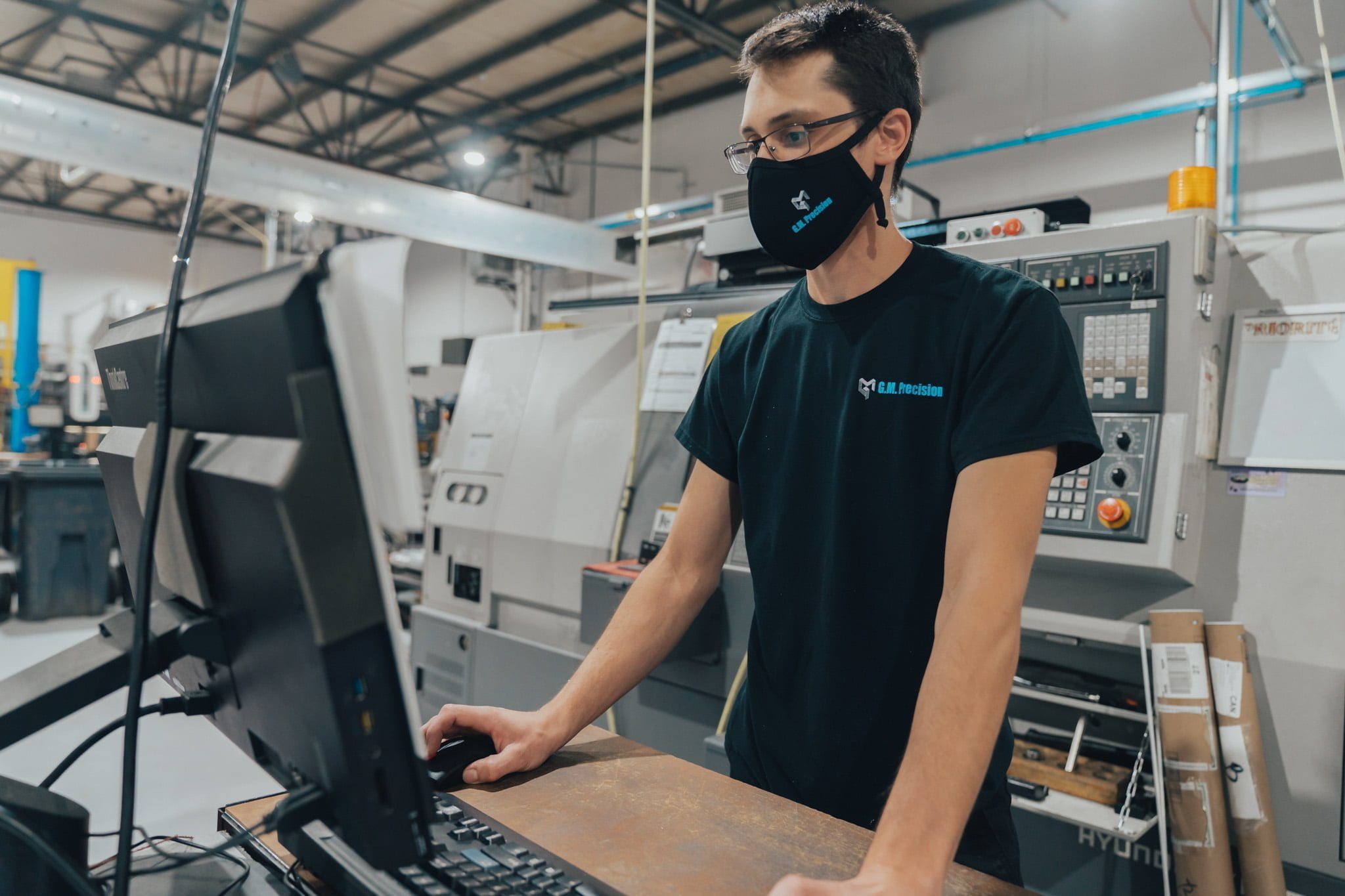 Member of the G.M. Précision team operates a machine